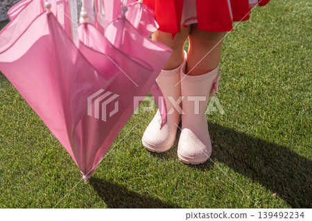 Child with an umbrella 139492234