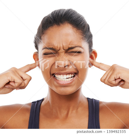 Face, sound and fingers in ears with an eyes closed woman in studio isolated on a white background. Stress, anxiety or loud with a frustrated young person feeling unhappy or overwhelmed by noise Face, sound and fingers in ears with an eyes closed woman in studio isolated on a white background. Stress, anxiety or loud with a frustrated young person feeling unhappy or overwhelmed by noise 139492335
