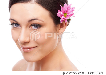 Portrait, flower and happy woman in studio for skincare, wellness or natural cosmetics on white background. Daisy, beauty or model face with floral cosmetology, shine or skin glow with spa aesthetic Portrait, flower and happy woman in studio for skincare, wellness or natural cosmetics on white background. Daisy, beauty or model face with floral cosmetology, shine or skin glow with spa aesthetic 139492371
