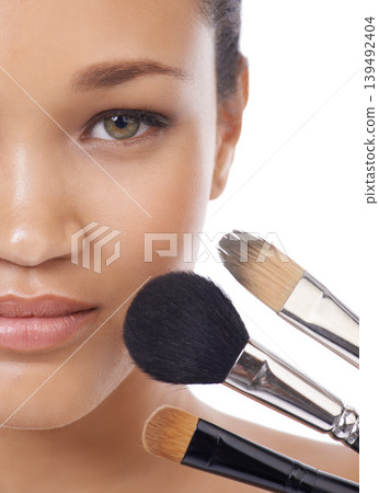 Makeup, brushes and portrait of young woman in studio for beauty, foundation and cosmetics. Face of a model, MUA artist and person with skincare, application tools and product on a white background 139492404