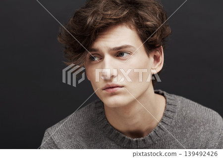 Young man, thinking and serious with model, casual fashion and gen z style with confidence in studio. Youth, hipster and male person with cool, trendy and minimalist clothes with black background Young man, thinking and serious with model, casual fashion and gen z style with confidence in studio. Youth, hipster and male person with cool, trendy and minimalist clothes with black background 139492426