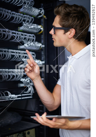 Server room, information technology and man with tablet, check connectivity and night job. Cybersecurity system, it network or person for fiber internet, data center or storage with cable connection Server room, information technology and man with tablet, check connectivity and night job. Cybersecurity system, it network or person for fiber internet, data center or storage with cable connection 139492617