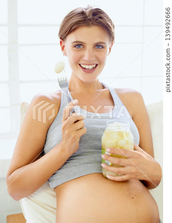 Pregnant woman, pickled onions and portrait in bedroom with gut health for vegetable nutrition in house. Young person, face or prenatal snack with fermented food for wellness and probiotics in home Pregnant woman, pickled onions and portrait in bedroom with gut health for vegetable nutrition in house. Young person, face or prenatal snack with fermented food for wellness and probiotics in home 139492666