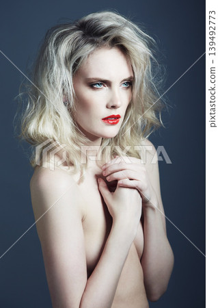 Beauty, nude and woman on blue background with makeup, cosmetics and red lipstick in studio. Model, aesthetic and person with frizzy hairstyle, naked and sexy with confidence, pride and art deco 139492773