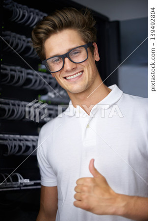 Server room, information technology and man with thumbs up for connectivity, night and job. Cybersecurity system, it network or person for fiber internet, data center or storage with cable connection Server room, information technology and man with thumbs up for connectivity, night and job. Cybersecurity system, it network or person for fiber internet, data center or storage with cable connection 139492804