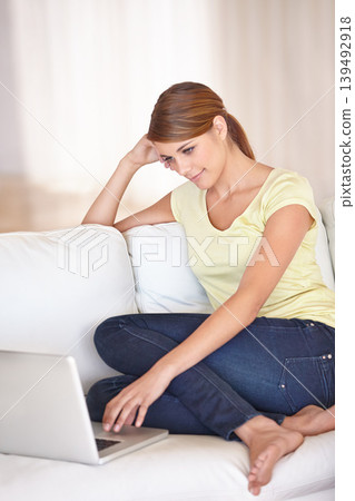 Woman, laptop and relax on sofa in home to watch movies, digital news subscription or streaming multimedia. Computer, online shopping or research blog, social network or happy download in living room Woman, laptop and relax on sofa in home to watch movies, digital news subscription or streaming multimedia. Computer, online shopping or research blog, social network or happy download in living room 139492918