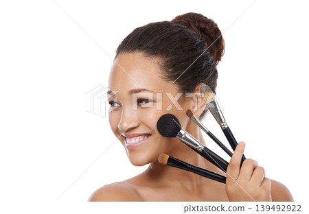 Makeup, brushes and happy woman in studio thinking of beauty, foundation and cosmetics. Face of young model, artist and person with skincare, application tools and product on a white background Makeup, brushes and happy woman in studio thinking of beauty, foundation and cosmetics. Face of young model, artist and person with skincare, application tools and product on a white background 139492922