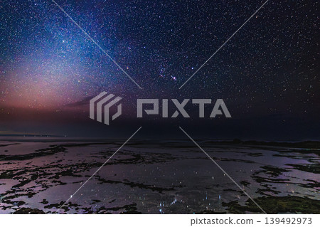 Orion and the Milky Way spread across the coast of Yakushima Island Orion and the Milky Way spread across the coast of Yakushima Island 139492973