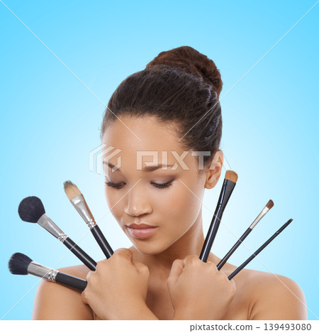 Woman, grooming and makeup brushes for cosmetics in studio, choice and decision for beauty. Female model person, tools and equipment for application, skincare and facial treatment by blue background Woman, grooming and makeup brushes for cosmetics in studio, choice and decision for beauty. Female model person, tools and equipment for application, skincare and facial treatment by blue background 139493080