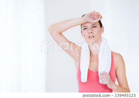Gym, space or tired athlete sweating in exercise, fitness training or workout break in studio. Healthy, fatigue or exhausted woman breathing on white background for sports or running performance Gym, space or tired athlete sweating in exercise, fitness training or workout break in studio. Healthy, fatigue or exhausted woman breathing on white background for sports or running performance 139493123