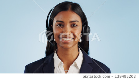 Happy woman, portrait and headphones for call center or telemarketing against a blue studio background. Face of female person, consultant or agent smile with mic for online advice on mockup space Happy woman, portrait and headphones for call center or telemarketing against a blue studio background. Face of female person, consultant or agent smile with mic for online advice on mockup space 139493208
