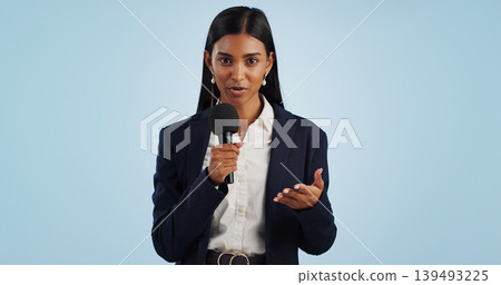 Woman, portrait or presenter in studio talking, speaking on talk show or media on blue background. Breaking news, tv press or Indian reporter presenting live global political events with microphone Woman, portrait or presenter in studio talking, speaking on talk show or media on blue background. Breaking news, tv press or Indian reporter presenting live global political events with microphone 139493225