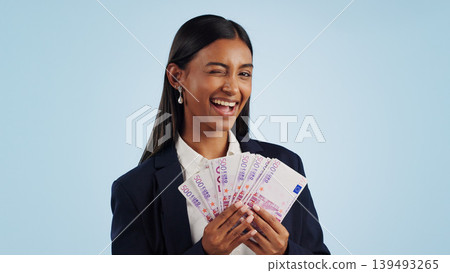 Business woman, portrait and wink with money fan in financial freedom against a blue studio background. Female person or employee with cash, savings or investment for bonus salary on mockup space Business woman, portrait and wink with money fan in financial freedom against a blue studio background. Female person or employee with cash, savings or investment for bonus salary on mockup space 139493265