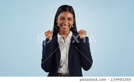 Winner, excited or happy woman in celebration for a business deal isolated on blue background. Wow, goals or proud Indian lady with smile, victory success or reward in entrepreneurship or studio Winner, excited or happy woman in celebration for a business deal isolated on blue background. Wow, goals or proud Indian lady with smile, victory success or reward in entrepreneurship or studio 139493269