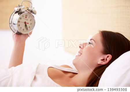 Alarm, clock and happy woman in a bed with morning, alert or bell ring for start of day or routine in her home. Time, wake up and female person smile in a bedroom after peaceful sleep, nap or resting Alarm, clock and happy woman in a bed with morning, alert or bell ring for start of day or routine in her home. Time, wake up and female person smile in a bedroom after peaceful sleep, nap or resting 139493308