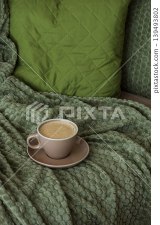Cozy Living Room with Coffee Cup on Green Blanket Cozy Living Room with Coffee Cup on Green Blanket 139493802