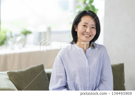A woman in her 40s smiles and looks directly at the camera. A woman in her 40s smiles and looks directly at the camera. 139493909