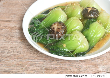 stir fried Chinese cabbage or Bok Choy topping black mushroom in gravy soy sauce on plate stir fried Chinese cabbage or Bok Choy topping black mushroom in gravy soy sauce on plate 139493912