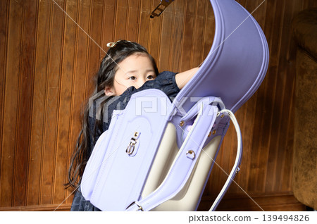 A Japanese girl opening her schoolbag A Japanese girl opening her schoolbag 139494826