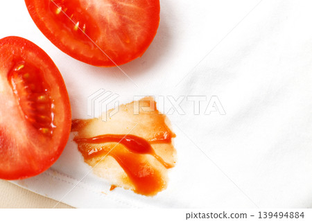 Tomatoes and ketchup stain on white shirt clothes Tomatoes and ketchup stain on white shirt clothes 139494884