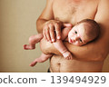 Closeup portrait of young father holding his newborn baby. Fathers day holiday, love, care concept. 139494929