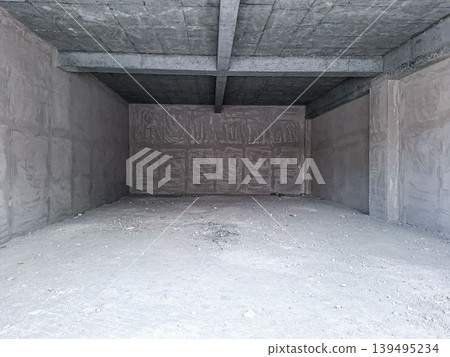 The scene shows an empty concrete room under construction. The walls are raw, and the floor is dusty. This space is ideal for future renovation or real estate ideas. The scene shows an empty concrete room under construction. The walls are raw, and the floor is dusty. This space is ideal for future renovation or real estate ideas. 139495234