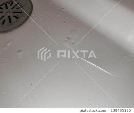Broken Acrylic Bathtub with Visible Crack and Moisture Broken Acrylic Bathtub with Visible Crack and Moisture 139495550