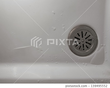 Damaged Bathtub Surface Near Drain in Bathroom Damaged Bathtub Surface Near Drain in Bathroom 139495552
