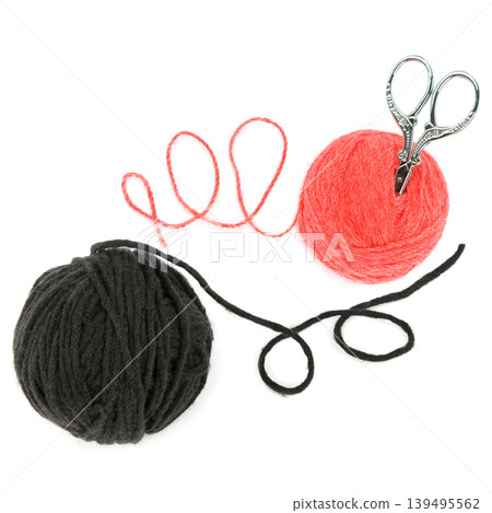 Black and red yarn balls with vintage scissors on white background Black and red yarn balls with vintage scissors on white background 139495562