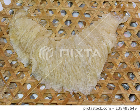 Premium dried shark fin delicacy on traditional bamboo tray Premium dried shark fin delicacy on traditional bamboo tray 139495649