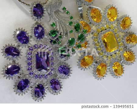 Luxury jewelry with purple and yellow gemstones on white background 139495651