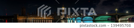 London United Kingdom panoramic night skyline Big Ben the Houses of Parliament and Westminster bridge illuminated clock tower riverside buildings reflection water at 12.20am. London United Kingdom panoramic night skyline Big Ben the Houses of Parliament and Westminster bridge illuminated clock tower riverside buildings reflection water at 12.20am. 139495708