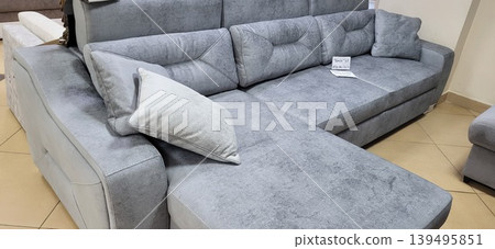 Brest, Belarus - 20.02.2024: Gray corner sofa with ergonomic pillow for human factors and posture comfort research 139495851