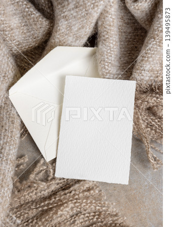 Blank card mockup with envelope on grey stone and beige blanket, copy space. Minimal stationery template Blank card mockup with envelope on grey stone and beige blanket, copy space. Minimal stationery template 139495873