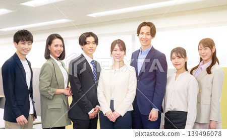 A group photo of business people lined up in an office. A group photo of business people lined up in an office. 139496078