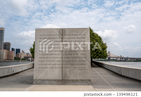New york, usa august 17,2024. Stone monument displaying four freedoms speech text, looking over east river with manhattan skyline and queensboro bridge New york, usa august 17,2024. Stone monument displaying four freedoms speech text, looking over east river with manhattan skyline and queensboro bridge 139496121