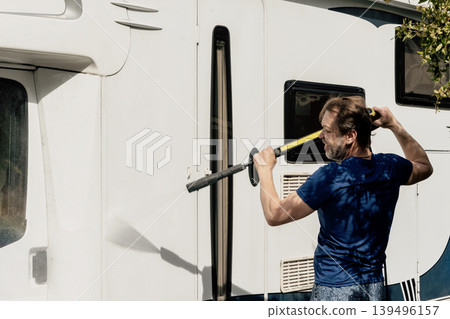 Man washing residential motorhome with pressure washer near private house in summer. 139496157
