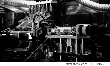 PET bottle machinery. Automated plastic bottle manufacturing machine operating on factory production line. Robot machine for bottle preform or forming packaging high speed plastic container production PET bottle machinery. Automated plastic bottle manufacturing machine operating on factory production line. Robot machine for bottle preform or forming packaging high speed plastic container production 139496635