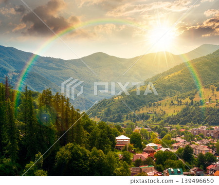 sunset over carpathian mountain landscape in summer. view in to the valley of rakhiv town near forested hill of mountain range. travel background of alpine ukraine countryside under the rainbow sunset over carpathian mountain landscape in summer. view in to the valley of rakhiv town near forested hill of mountain range. travel background of alpine ukraine countryside under the rainbow 139496650