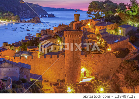 lluminated Medieval Fortress and Coastal Town at Dusk in Tossa de Mar lluminated Medieval Fortress and Coastal Town at Dusk in Tossa de Mar 139497122