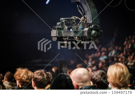 Professional broadcast camera rig filming live audience at indoor event production and concert coverage Professional broadcast camera rig filming live audience at indoor event production and concert coverage 139497179