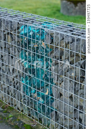 Unique design of colored stones in fence 139497725