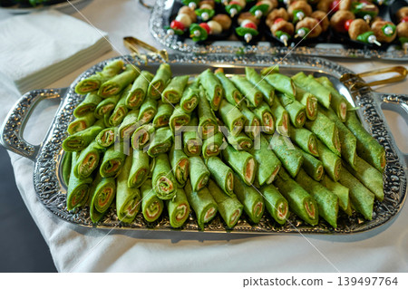 Colorful green wraps delight at festive table Colorful green wraps delight at festive table 139497764