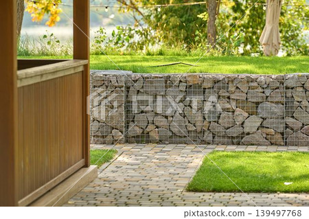 Outdoor stone wall and pathway create harmony Outdoor stone wall and pathway create harmony 139497768