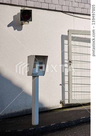 Elegant mailbox stands by a gated wall Elegant mailbox stands by a gated wall 139497805
