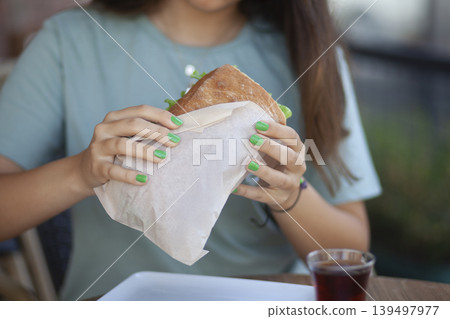 Woman Holding Sandwich. Casual Lunch with Sandwich in Woman Hand. Woman Holding Sandwich. Casual Lunch with Sandwich in Woman Hand. 139497977