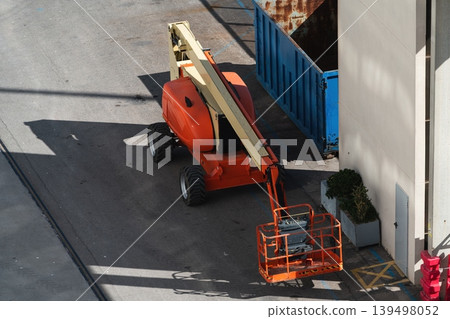 Boom lift in industrial yard Boom lift in industrial yard 139498052
