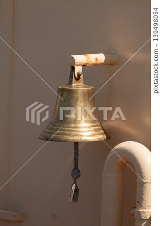 Brass ship bell on vessel wall Brass ship bell on vessel wall 139498054