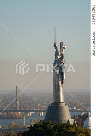 Motherland Monument in Kyiv with raised sword and shield, overlooking the Dnieper River, bridge and city panorama in Ukraine 139498065