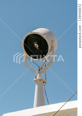 Ship searchlight on vessel against blue sky 139498072
